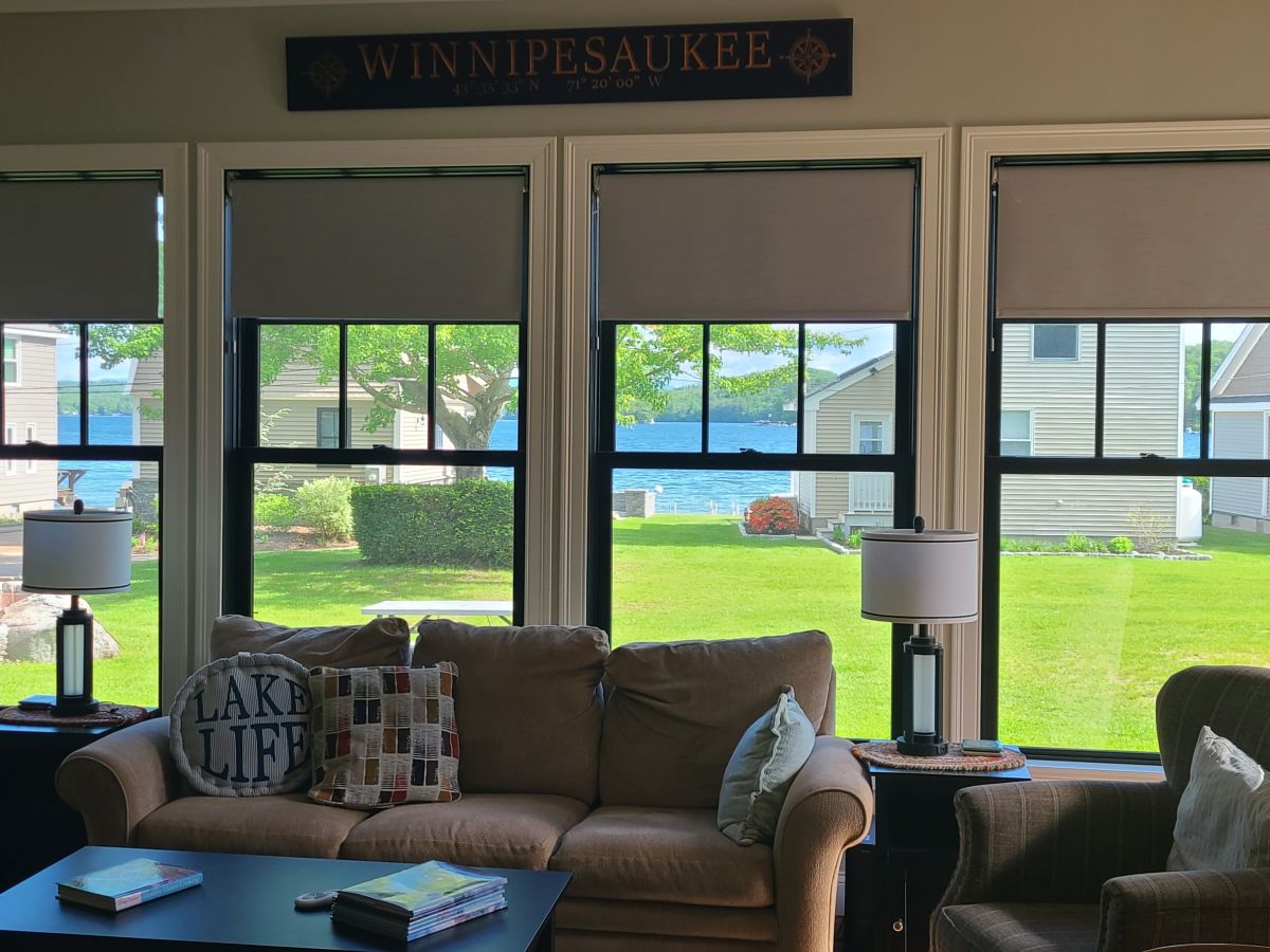 Unwind in your comfortable living room with stunning lake views through expansive windows. Picture yourself relaxing here after a day of lakeside adventures.