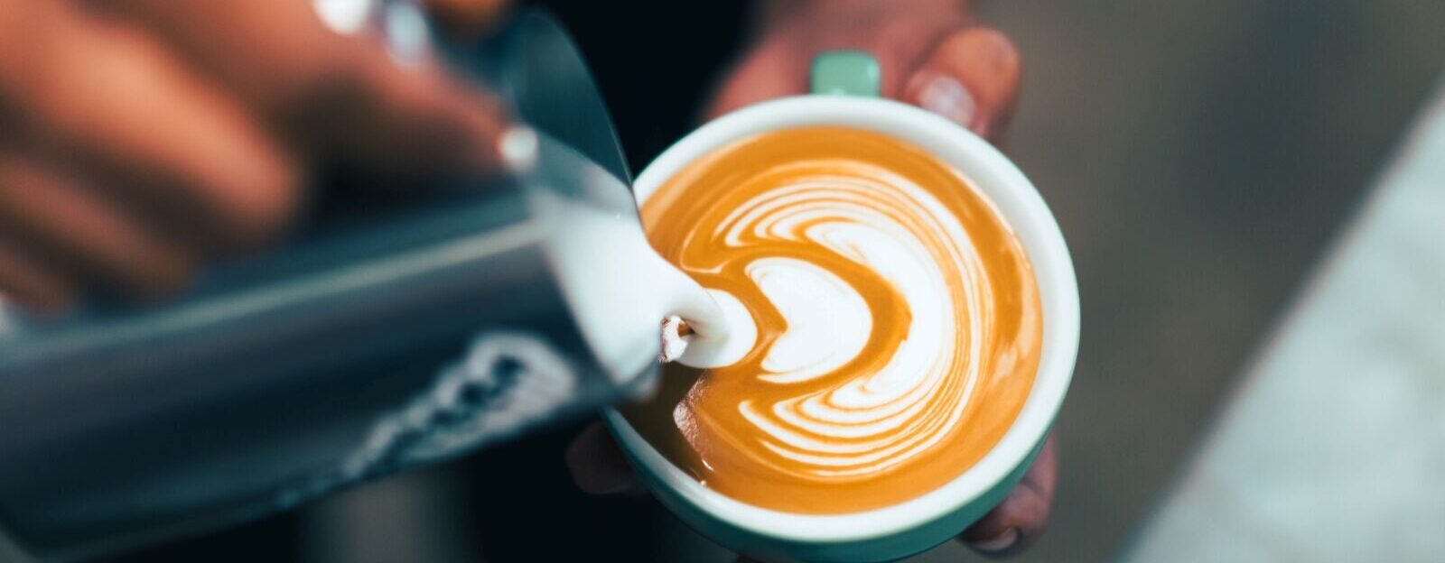 Barista pouring latte art.