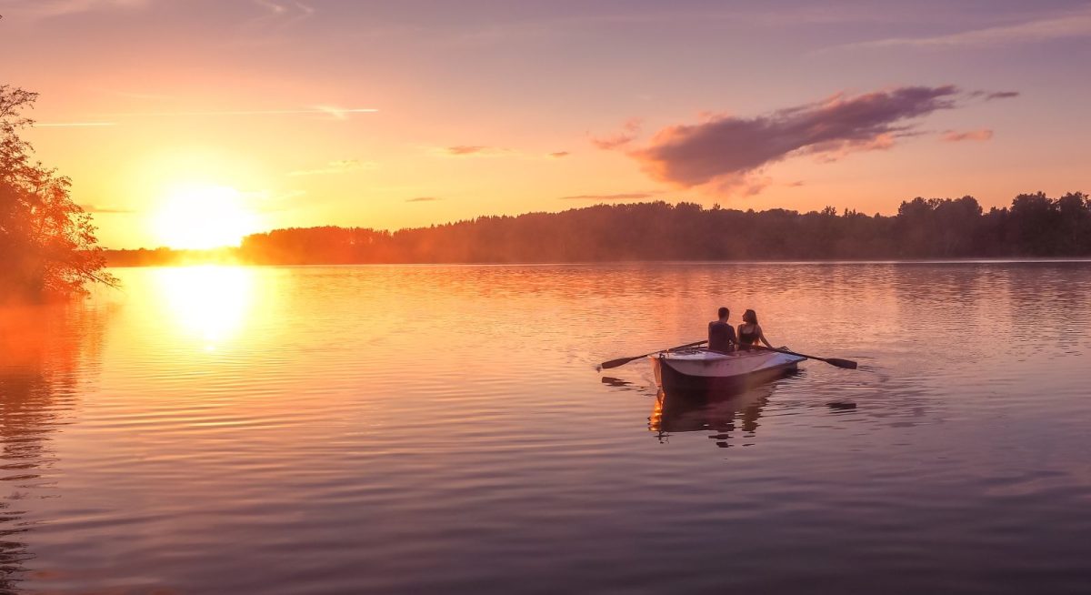 rowboat on lake at sunset