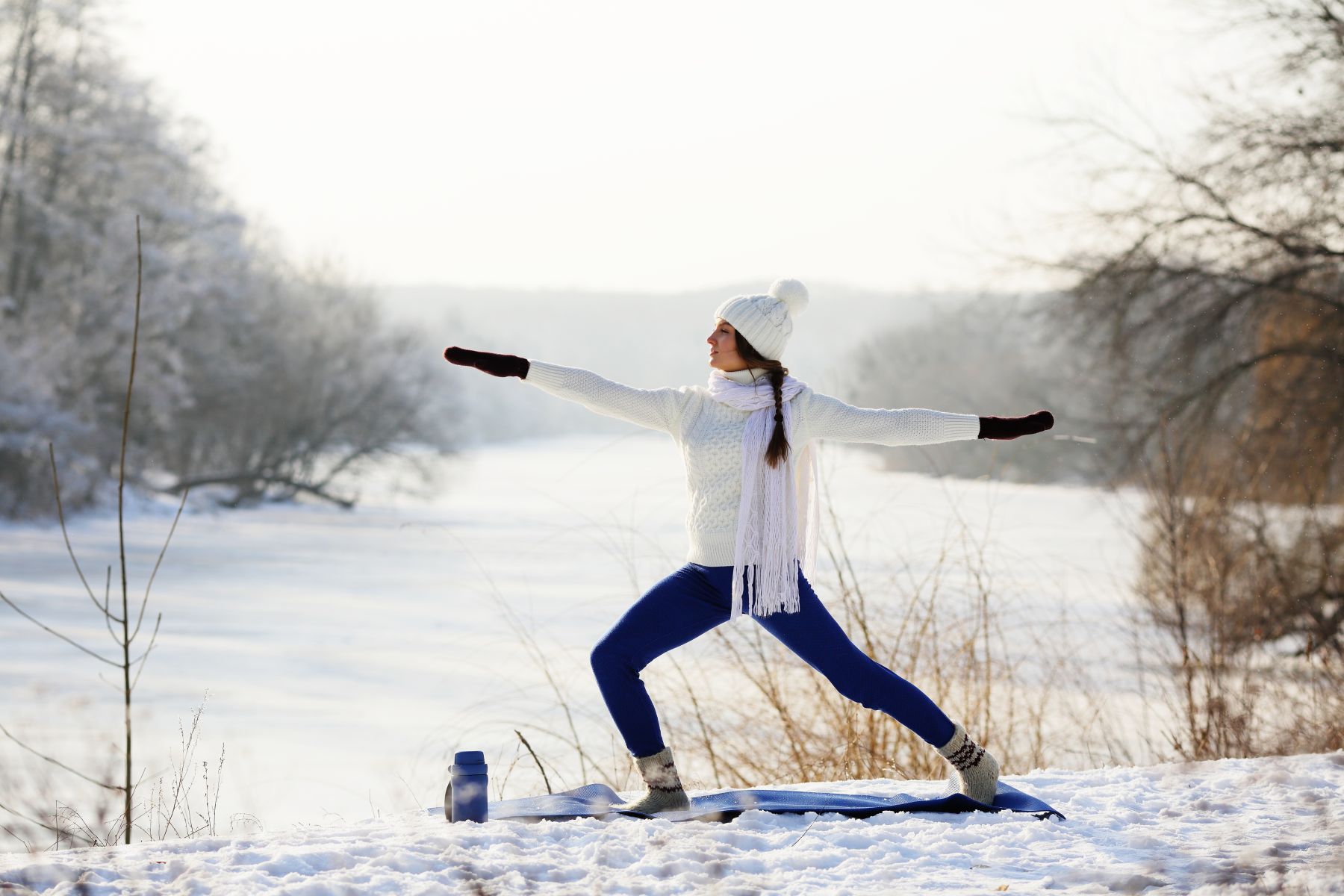 woman doing yoga in the snow